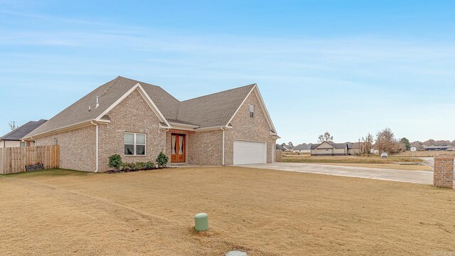 view of front of house featuring a garage and a front yard