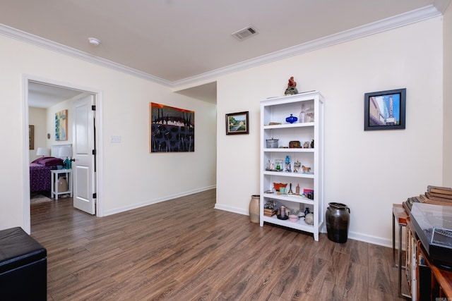 interior space featuring ornamental molding and dark wood-type flooring