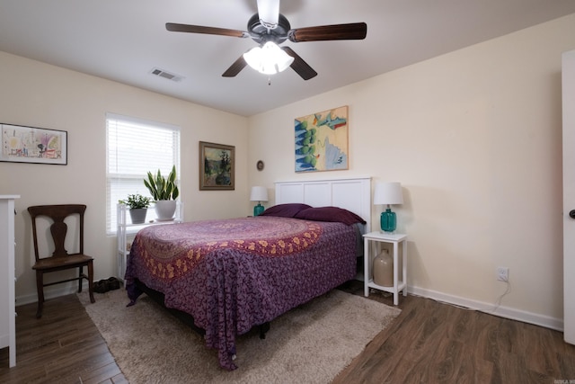 bedroom with ceiling fan and dark wood-type flooring