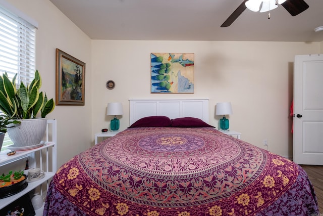 bedroom with ceiling fan and wood-type flooring