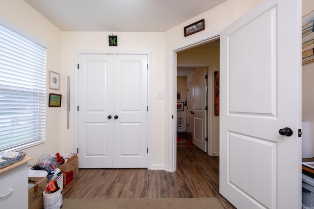 hallway with dark hardwood / wood-style flooring