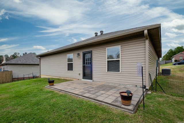 back of house with a yard, a patio, and central air condition unit