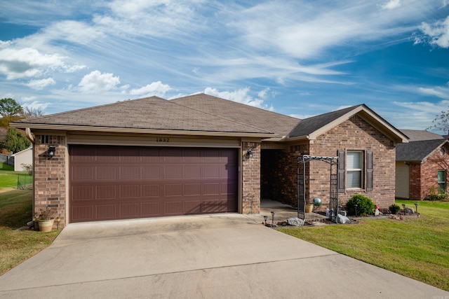 ranch-style house featuring a garage and a front yard