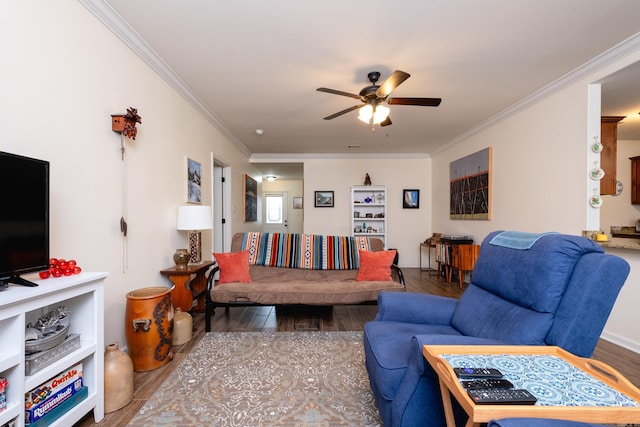 living room featuring hardwood / wood-style floors, ceiling fan, and crown molding