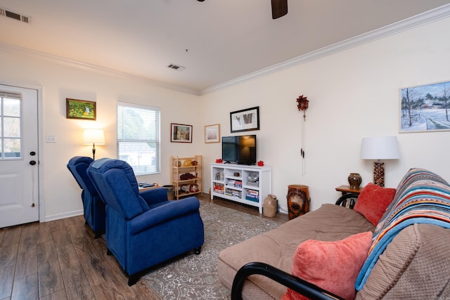 living room featuring dark hardwood / wood-style floors, ceiling fan, and ornamental molding