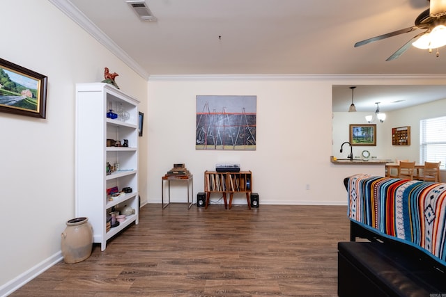 sitting room with ceiling fan, dark hardwood / wood-style flooring, and ornamental molding