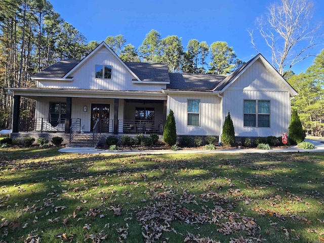 view of front facade with covered porch and a front yard