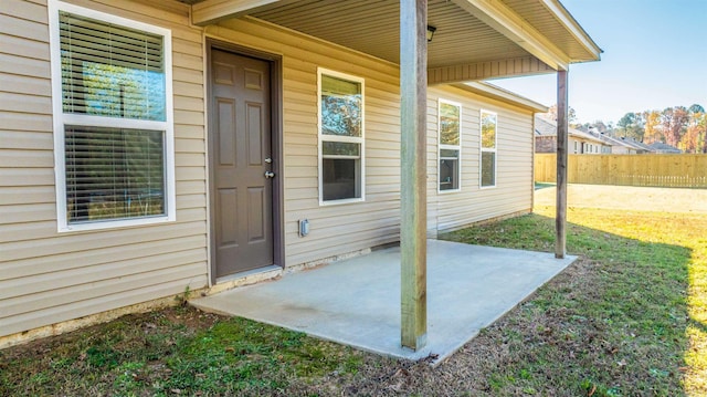 view of exterior entry featuring a patio