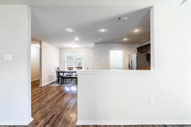 kitchen featuring stainless steel fridge with ice dispenser and dark hardwood / wood-style floors