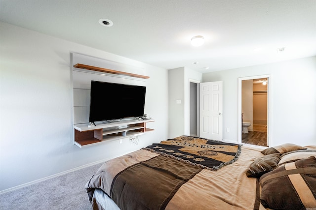 carpeted bedroom featuring ensuite bath