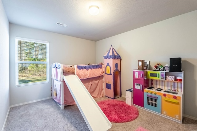 bedroom with a textured ceiling and carpet floors