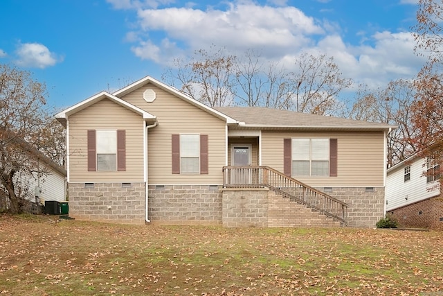 view of front facade with central air condition unit and a front lawn