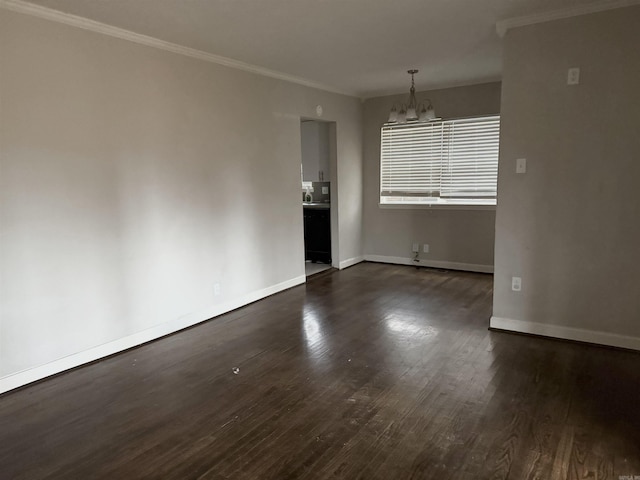 interior space with dark hardwood / wood-style floors, an inviting chandelier, and crown molding