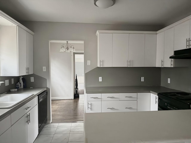 kitchen featuring white cabinets, black appliances, and a notable chandelier