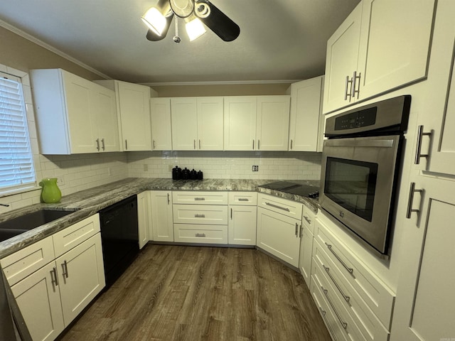 kitchen with dark hardwood / wood-style floors, white cabinetry, ornamental molding, and black appliances