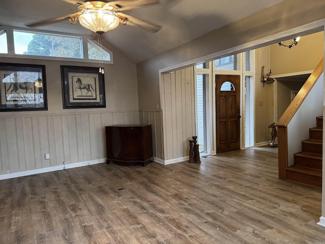 foyer entrance featuring ceiling fan, wood-type flooring, and vaulted ceiling