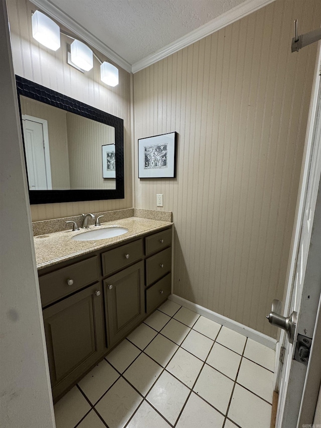 bathroom featuring tile patterned flooring, crown molding, a textured ceiling, wooden walls, and vanity