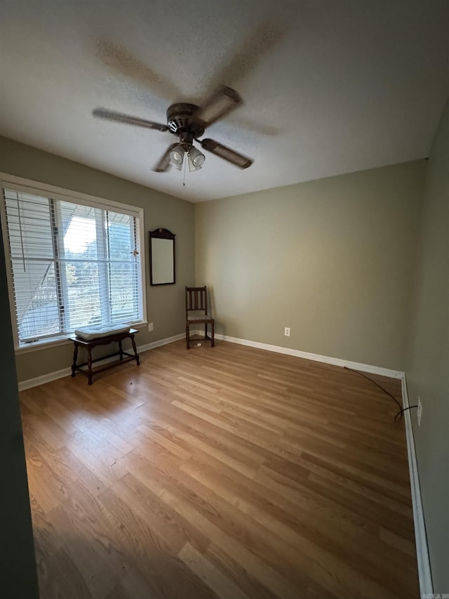 spare room featuring hardwood / wood-style floors, a textured ceiling, and ceiling fan