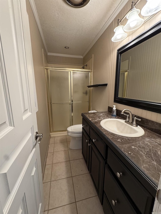 bathroom with vanity, a shower with door, tile patterned floors, crown molding, and a textured ceiling