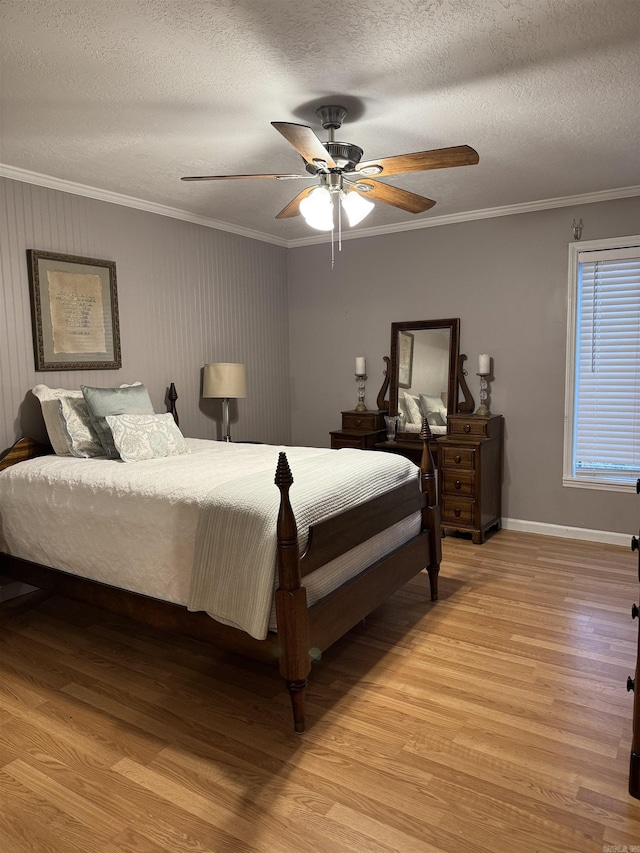 bedroom featuring ceiling fan, light wood-type flooring, and a textured ceiling