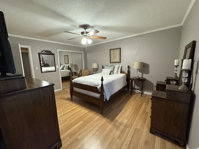 bedroom with ceiling fan, light wood-type flooring, a textured ceiling, and ornamental molding