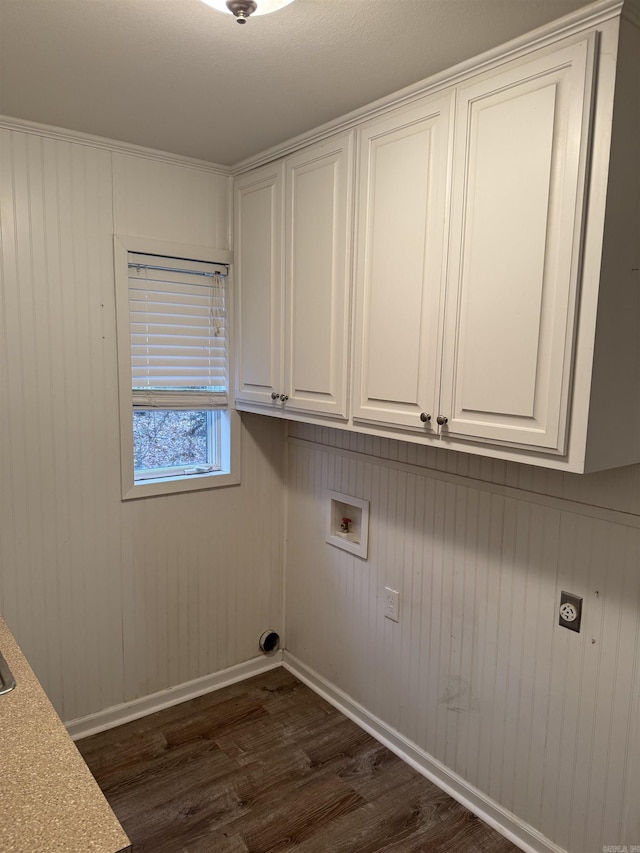 laundry area featuring cabinets, washer hookup, wooden walls, dark wood-type flooring, and electric dryer hookup