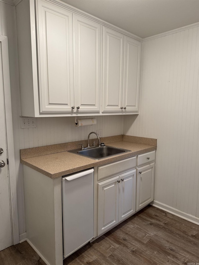 kitchen with dishwasher, dark hardwood / wood-style flooring, white cabinetry, and sink