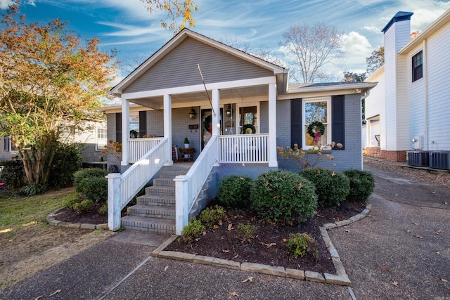 view of front of property with a porch and cooling unit