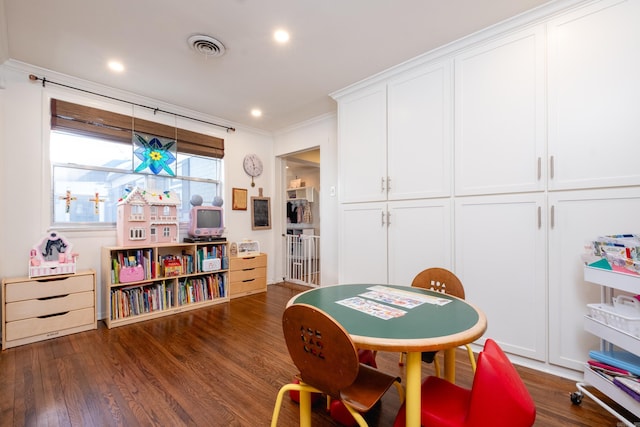 playroom with crown molding and dark hardwood / wood-style flooring