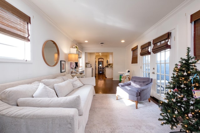 living room with french doors, a water view, ornamental molding, and hardwood / wood-style flooring