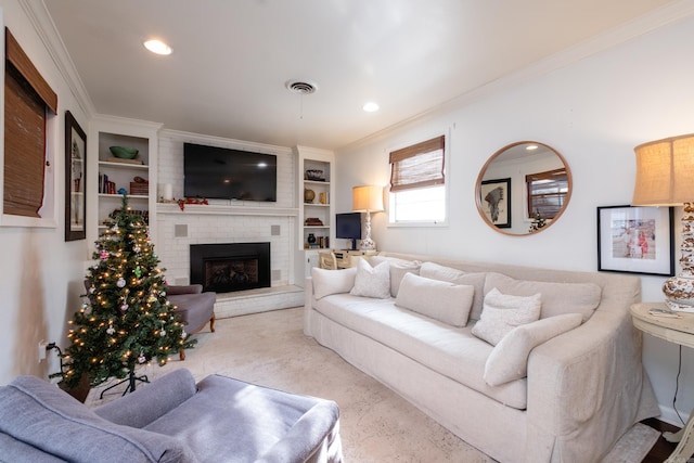 living room featuring built in shelves, ornamental molding, and a brick fireplace