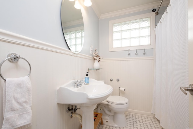 bathroom featuring crown molding and toilet