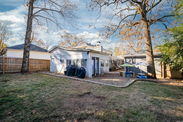 rear view of house featuring a yard