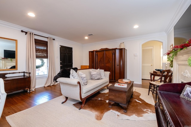 living room featuring dark hardwood / wood-style flooring and ornamental molding