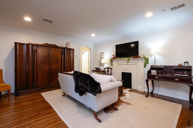 living room featuring ornamental molding and dark wood-type flooring