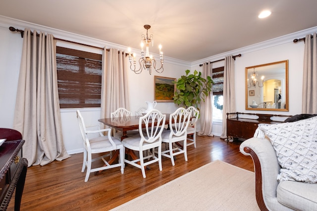 dining area featuring a chandelier, dark hardwood / wood-style floors, and ornamental molding