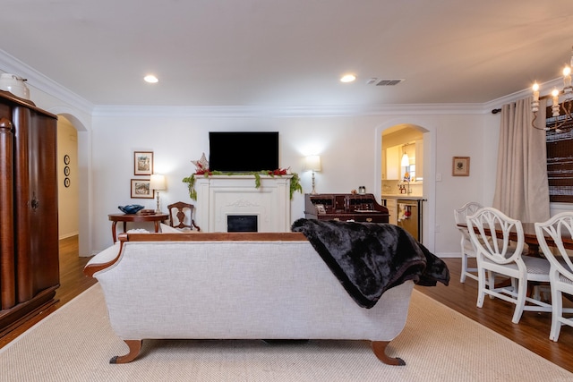 living room featuring hardwood / wood-style floors and ornamental molding