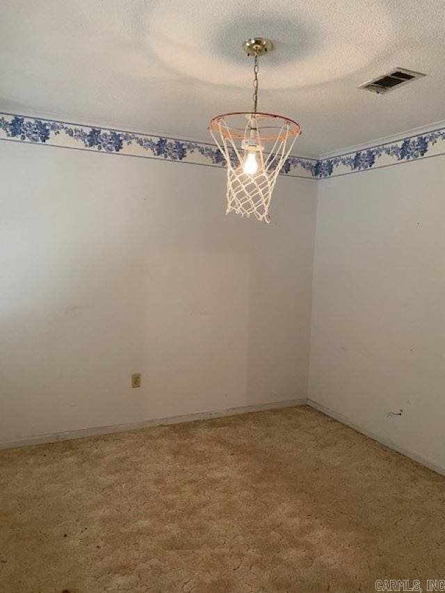 spare room with a textured ceiling