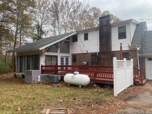 rear view of property with central air condition unit and a wooden deck