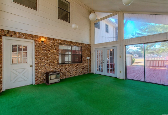 unfurnished sunroom with heating unit and french doors