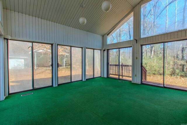 unfurnished sunroom with lofted ceiling