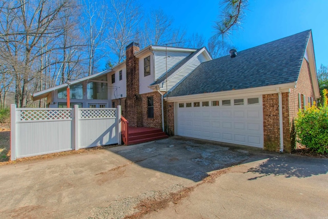 view of front of home featuring a wooden deck and a garage