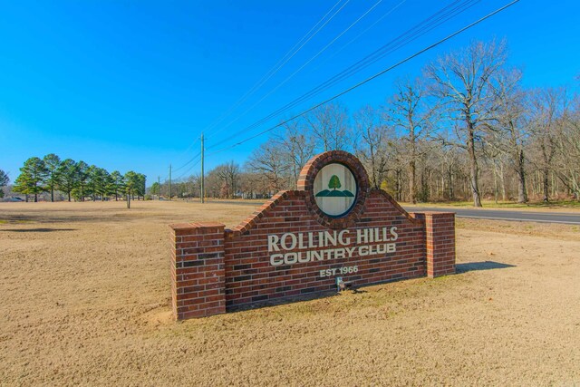 community / neighborhood sign featuring a lawn