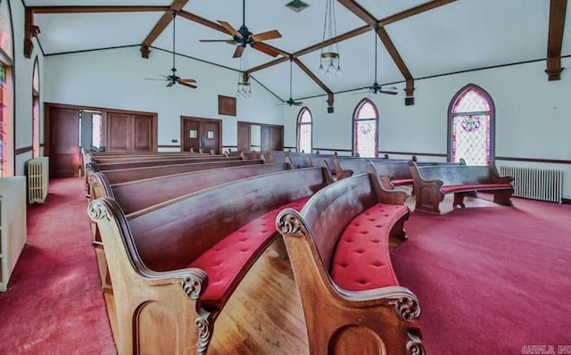 miscellaneous room featuring beam ceiling, light colored carpet, radiator heating unit, and high vaulted ceiling