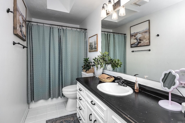 bathroom with tile patterned flooring, vanity, and toilet