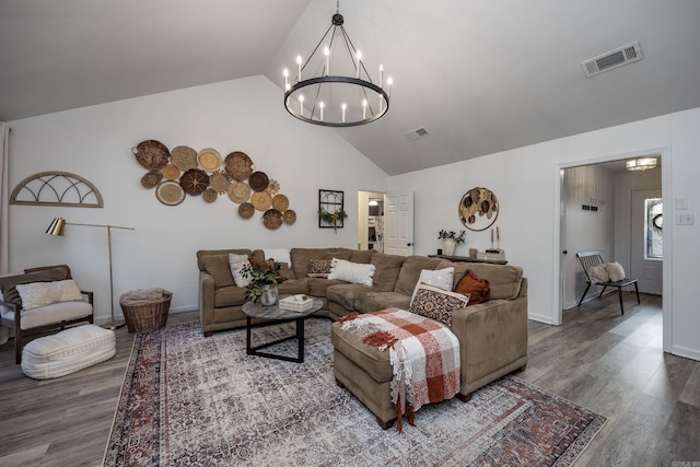 living room featuring lofted ceiling, an inviting chandelier, and dark wood-type flooring