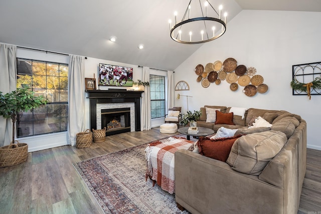 living room with a chandelier, wood-type flooring, and lofted ceiling