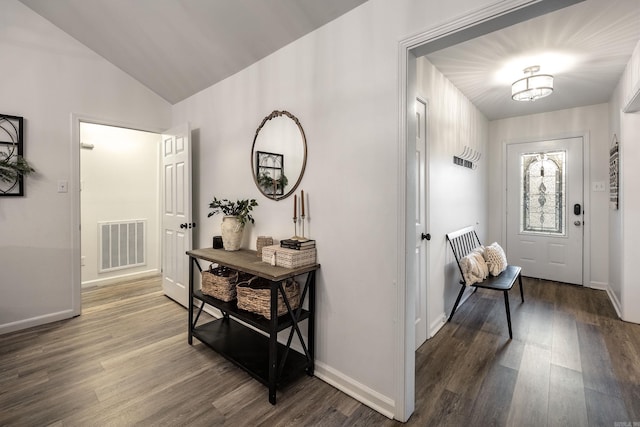 entryway with dark wood-type flooring and lofted ceiling