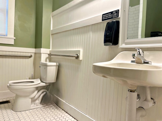 bathroom featuring toilet and tile patterned floors