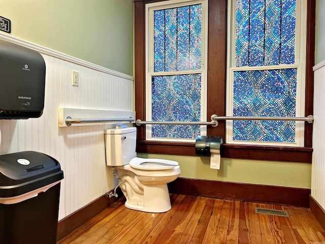 bathroom featuring hardwood / wood-style flooring and toilet